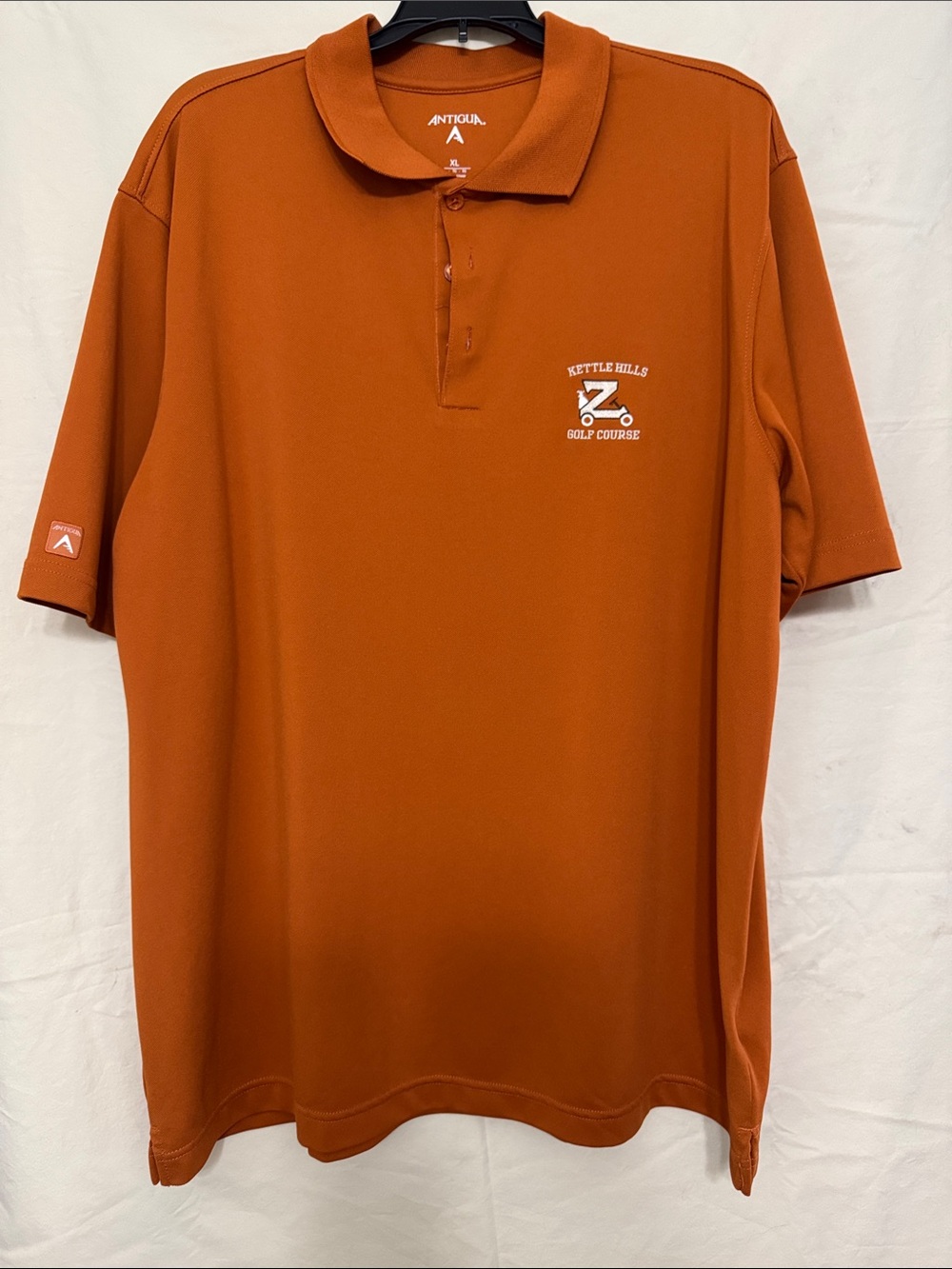 Antigua Kettle Hills Golf Course Men's Polo - Burnt Orange
